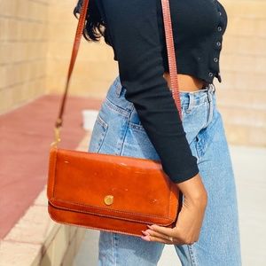 Vintage brown leather clutch with long strap